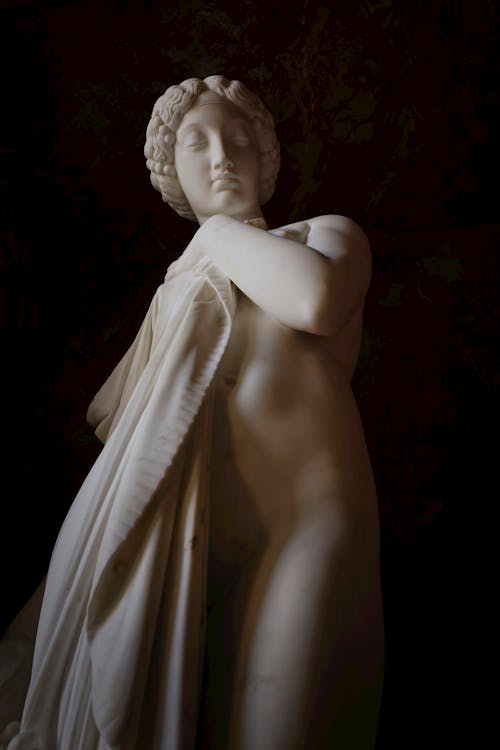 Naked Ancient Goddess Stone Sculpture on Black Background