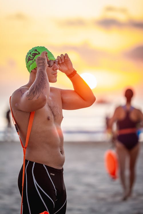 Man Wearing a Swimming Cap on a Beach 