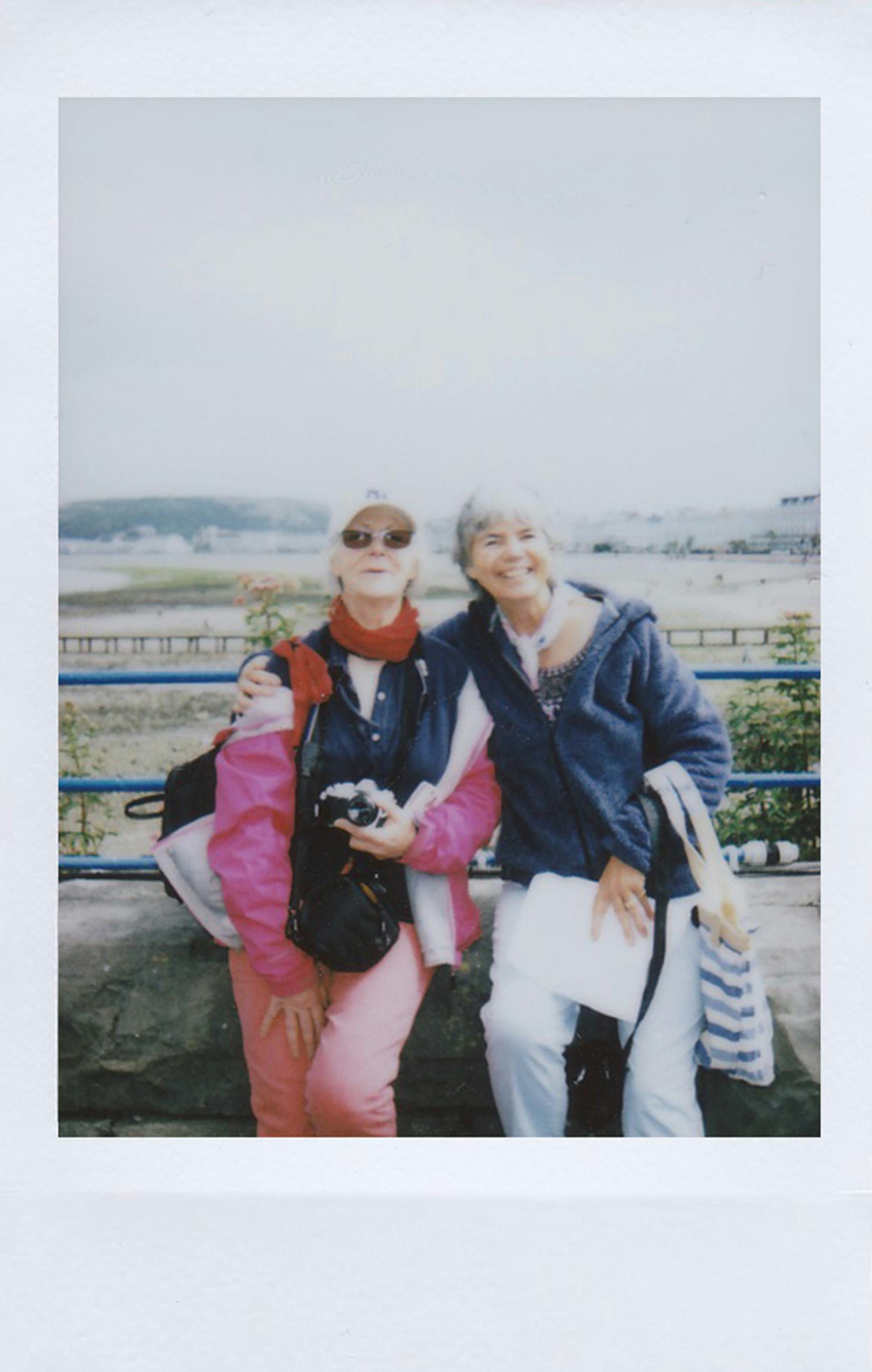 Joyful senior women enjoying a day out together, capturing memories.