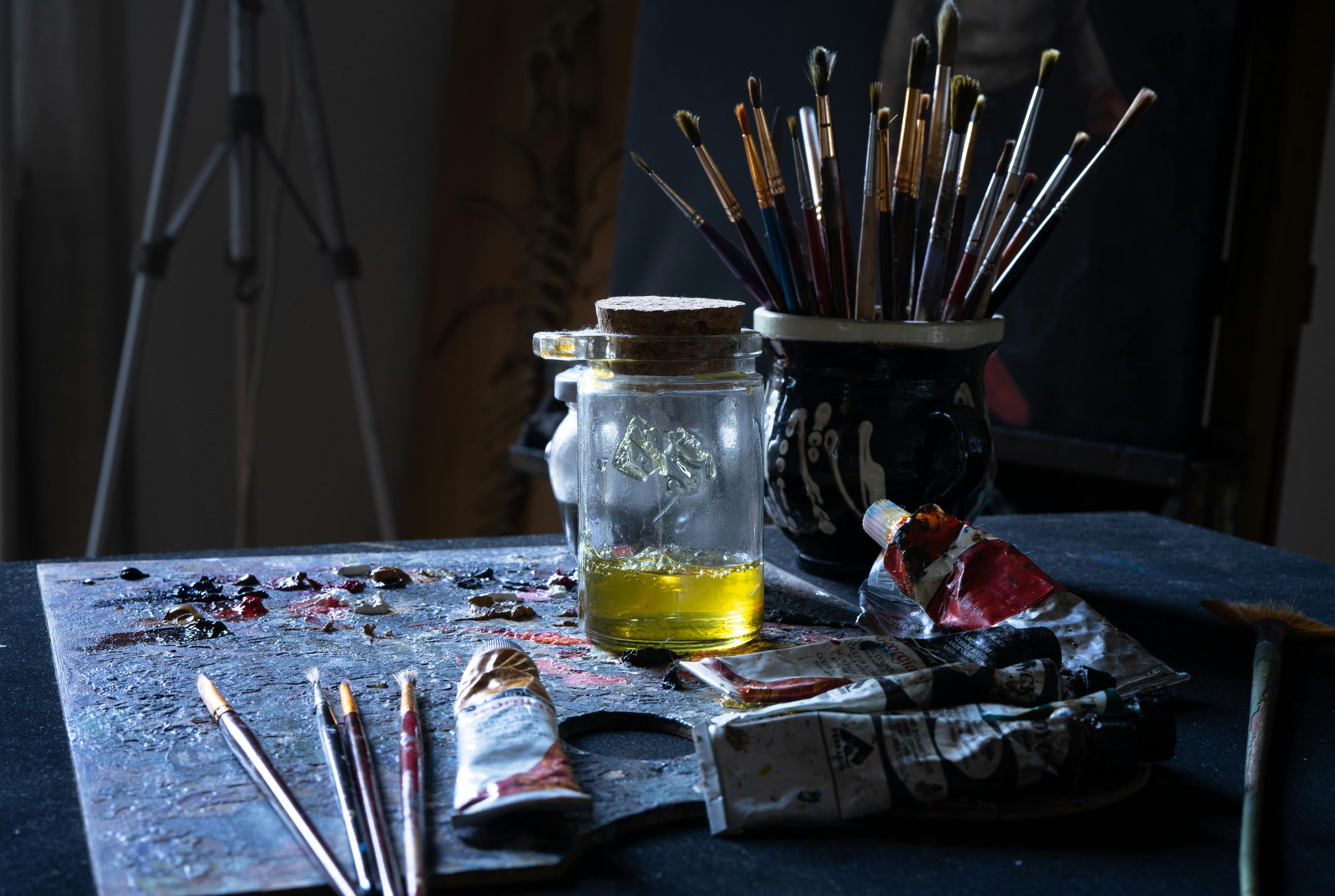 A close up of paint and brushes on a table Image & Design ID 0000370069 