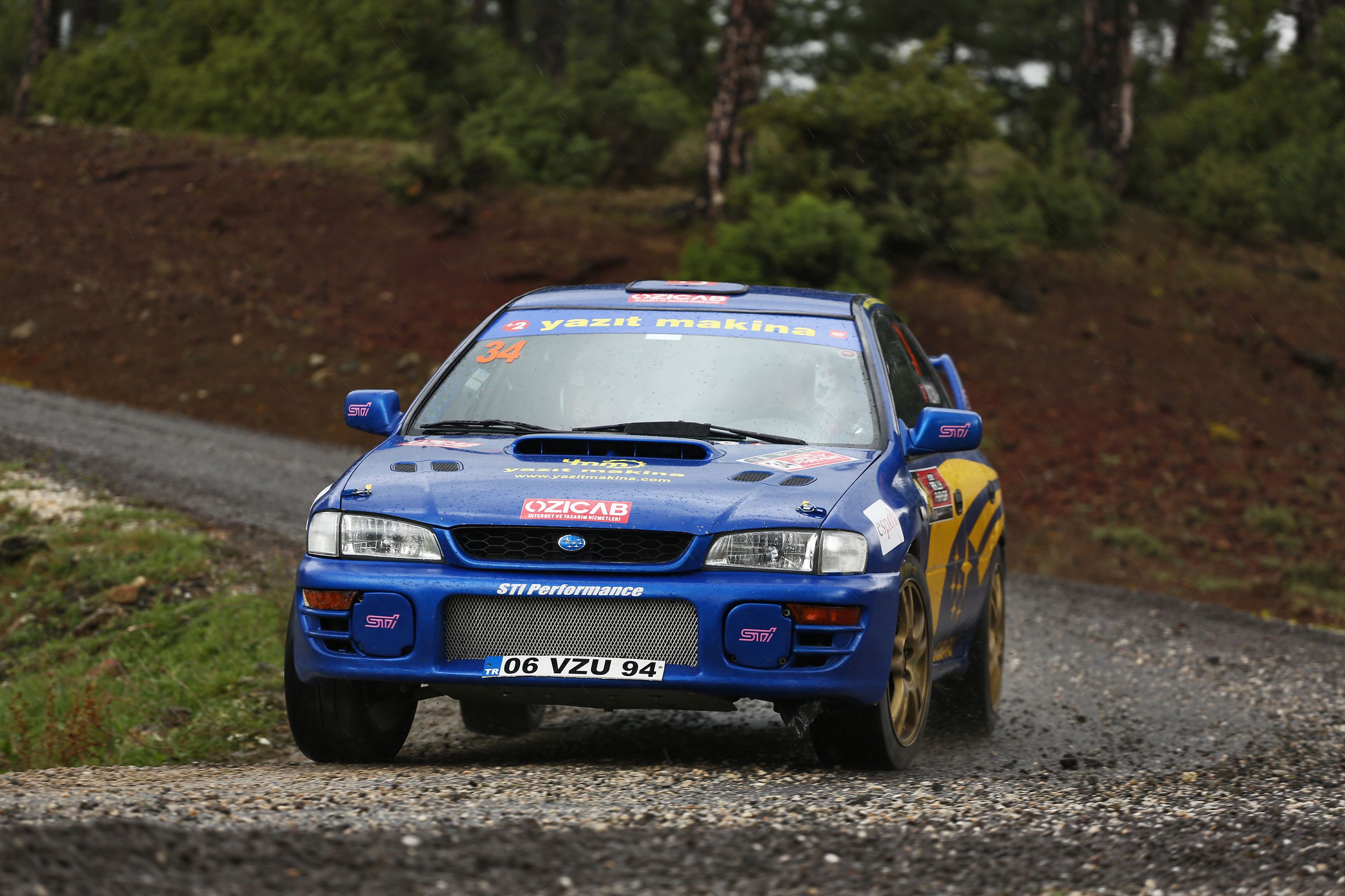 Blue Subaru rally car speeding on a dirt road in Eskişehir, Türkiye.