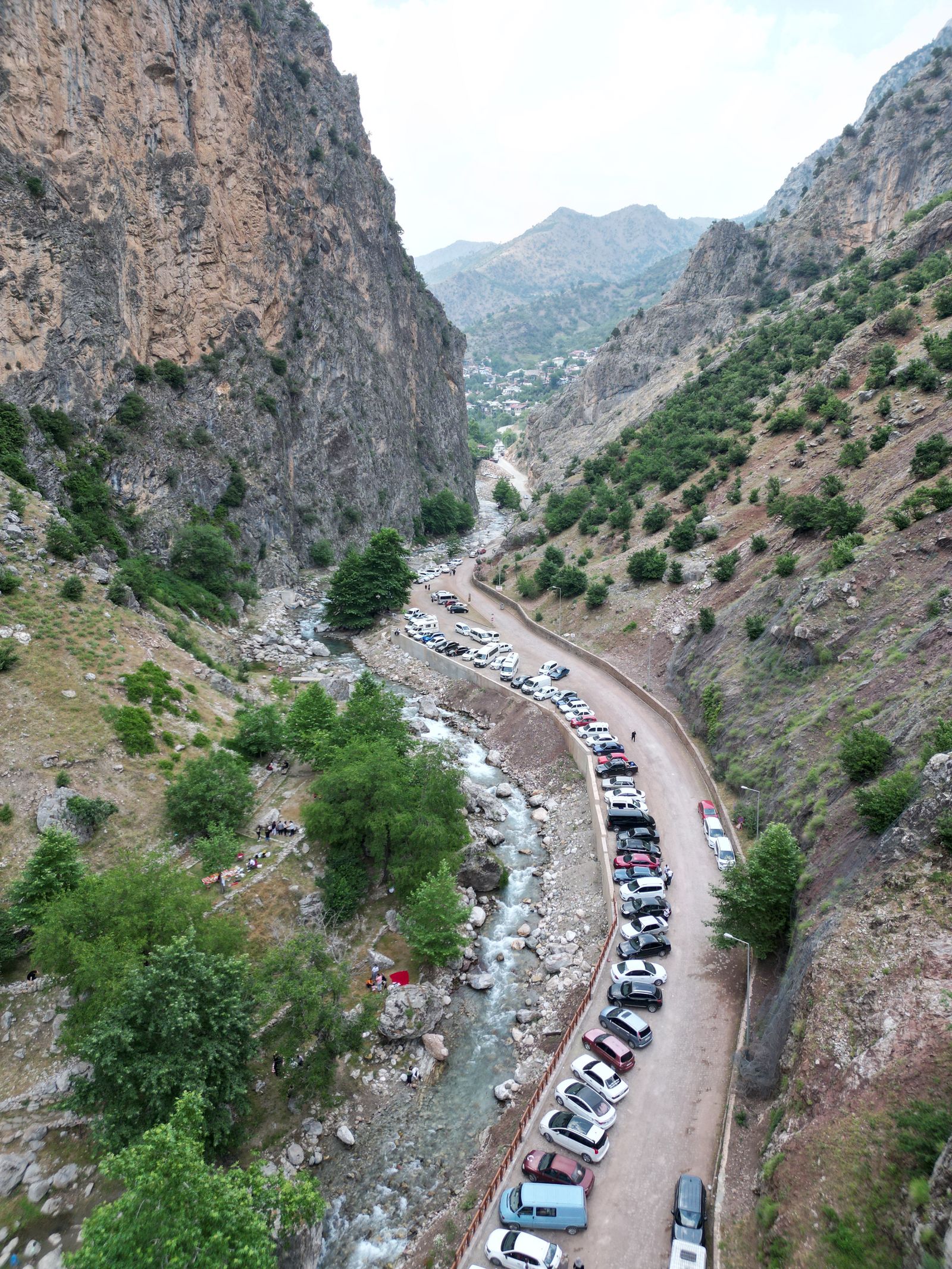 Parked cars in a mountain region surrounded by high peaks