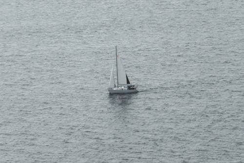 Free A sailboat is sailing in the ocean Stock Photo