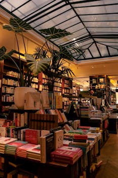Explore a charming Parisian bookstore with a stunning skylight ceiling and a diverse collection of books.