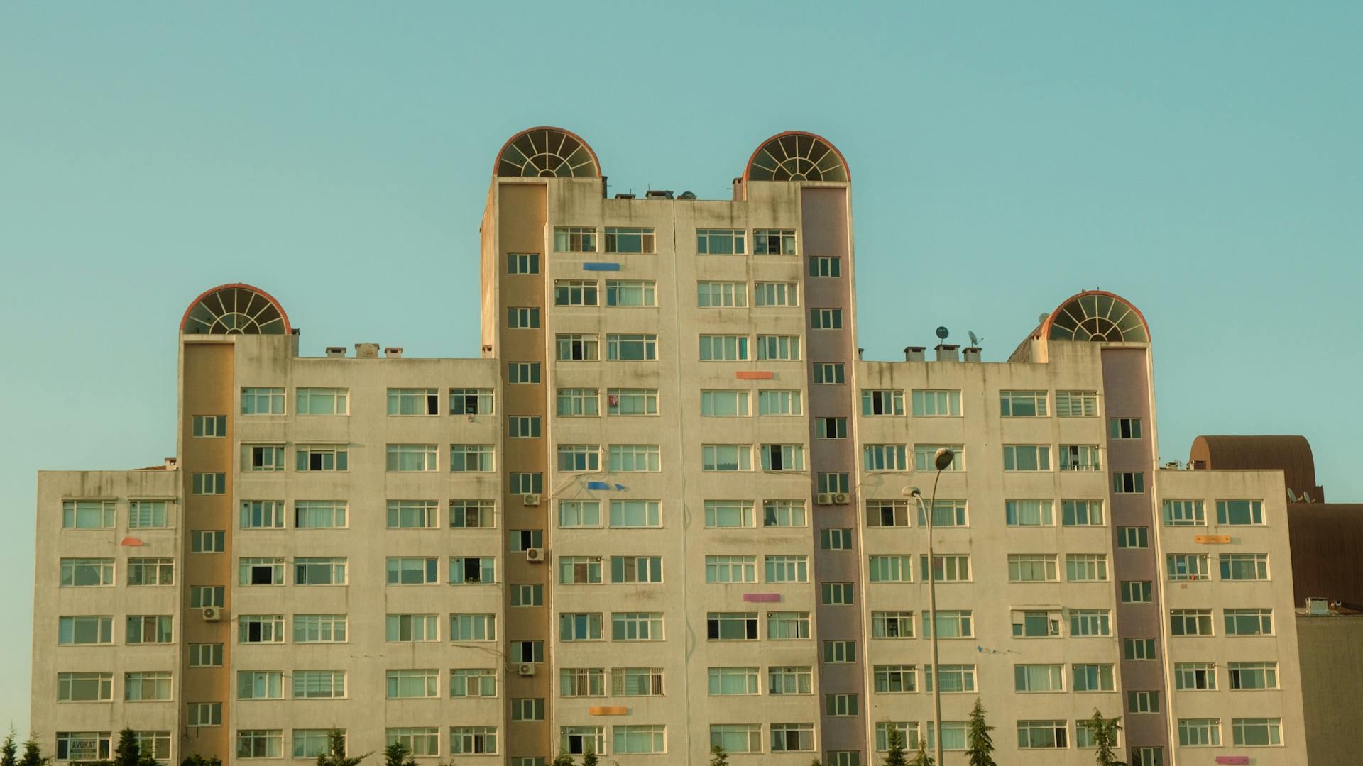 A high-rise apartment block in Istanbul with unique architectural design against a clear sky.