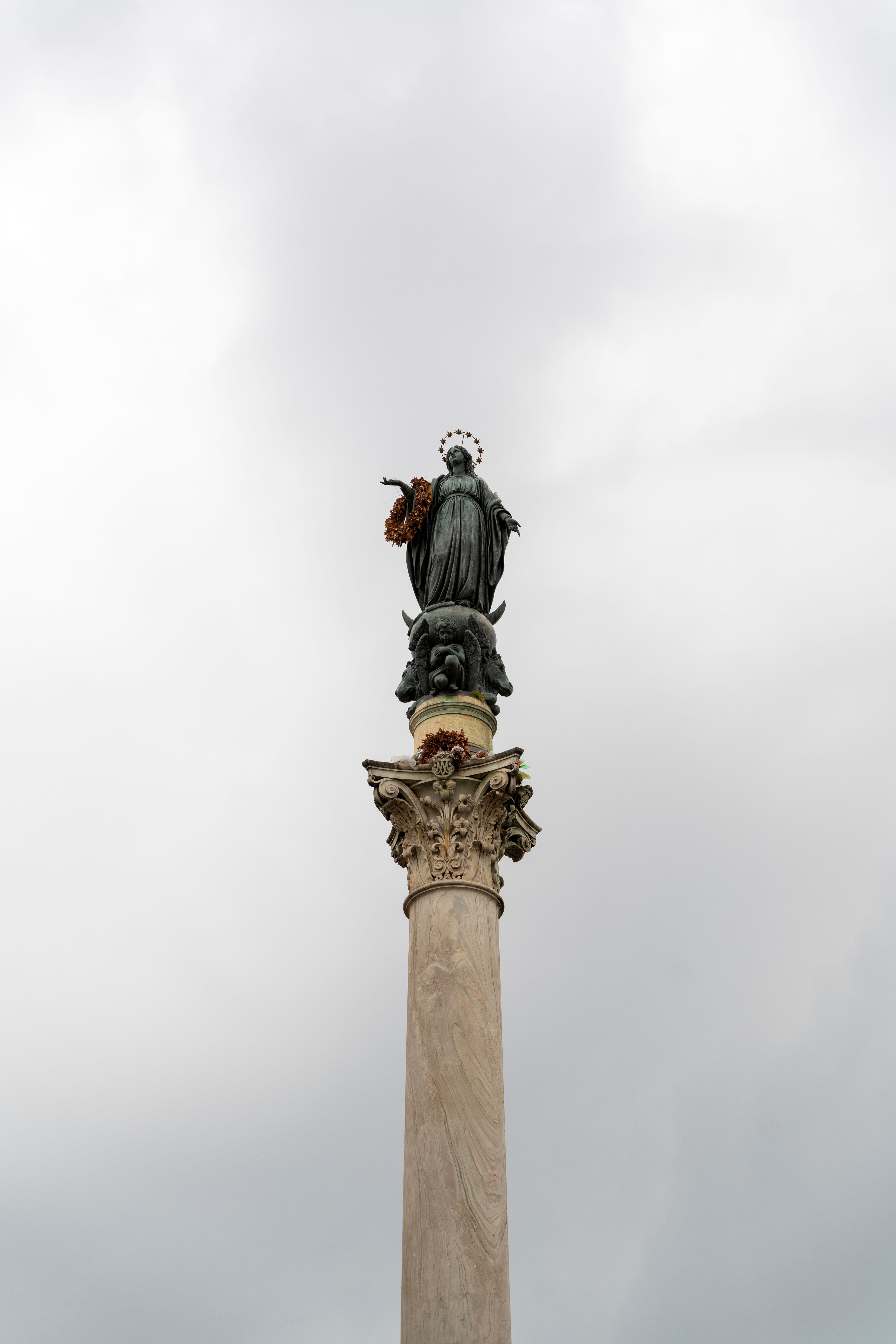 Elegant statue of the Virgin Mary atop a column in Rome, Italy.