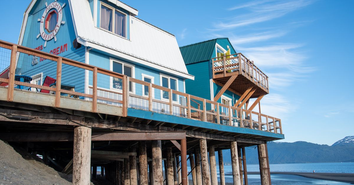 Colorful beach shop on stilts by the water on Kodiak Island, Alaska.