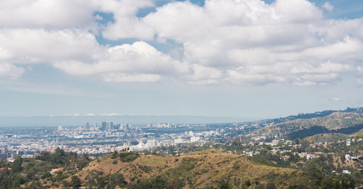 A sweeping view of Los Angeles cityscape from Griffith Park on a sunny day.
