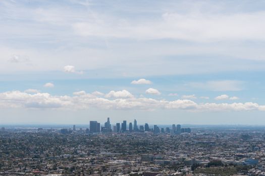 A stunning aerial view of the Los Angeles skyline under a clear blue sky.