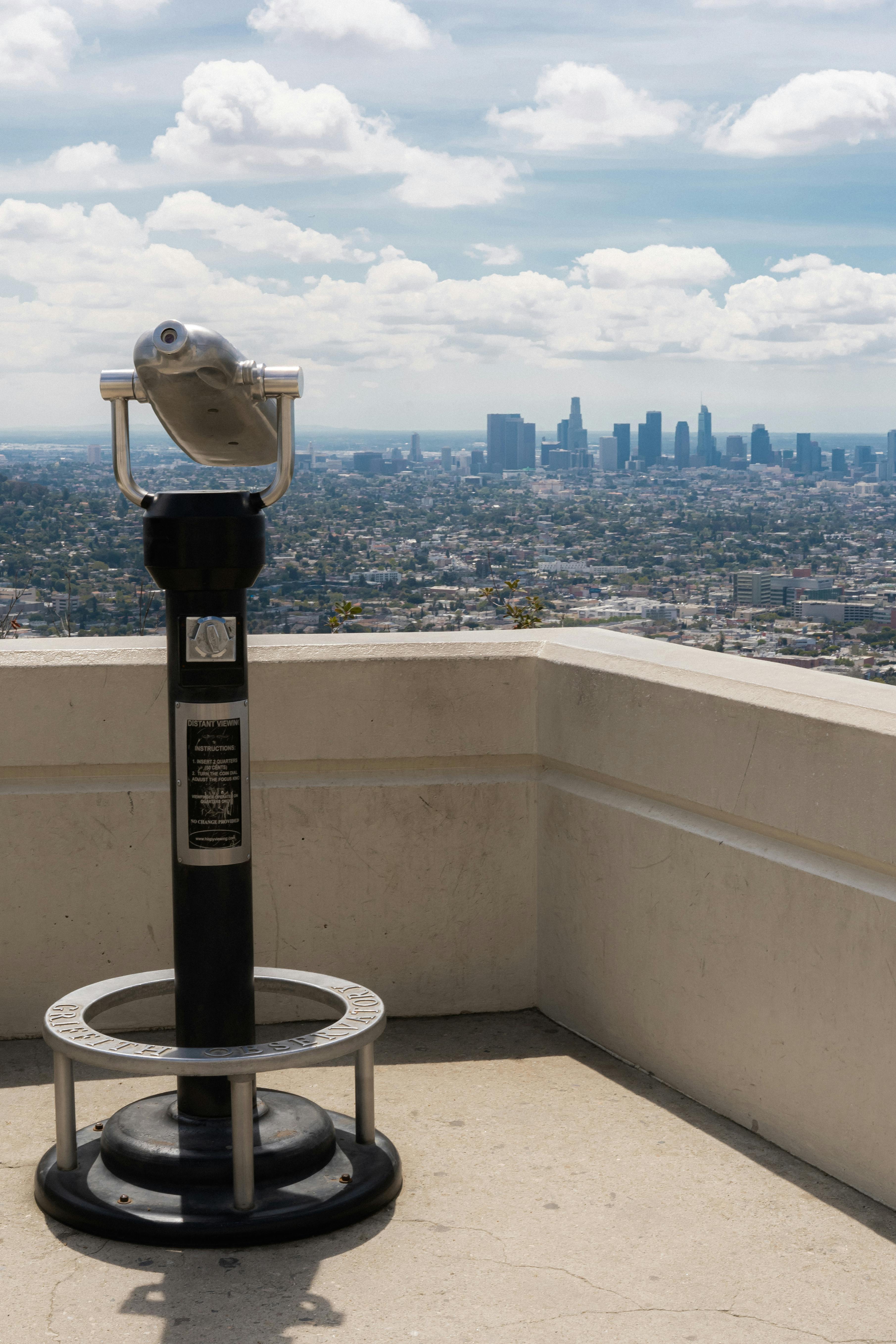 Stunning view of Los Angeles skyline from a terrace with a telescope overlooking the city.