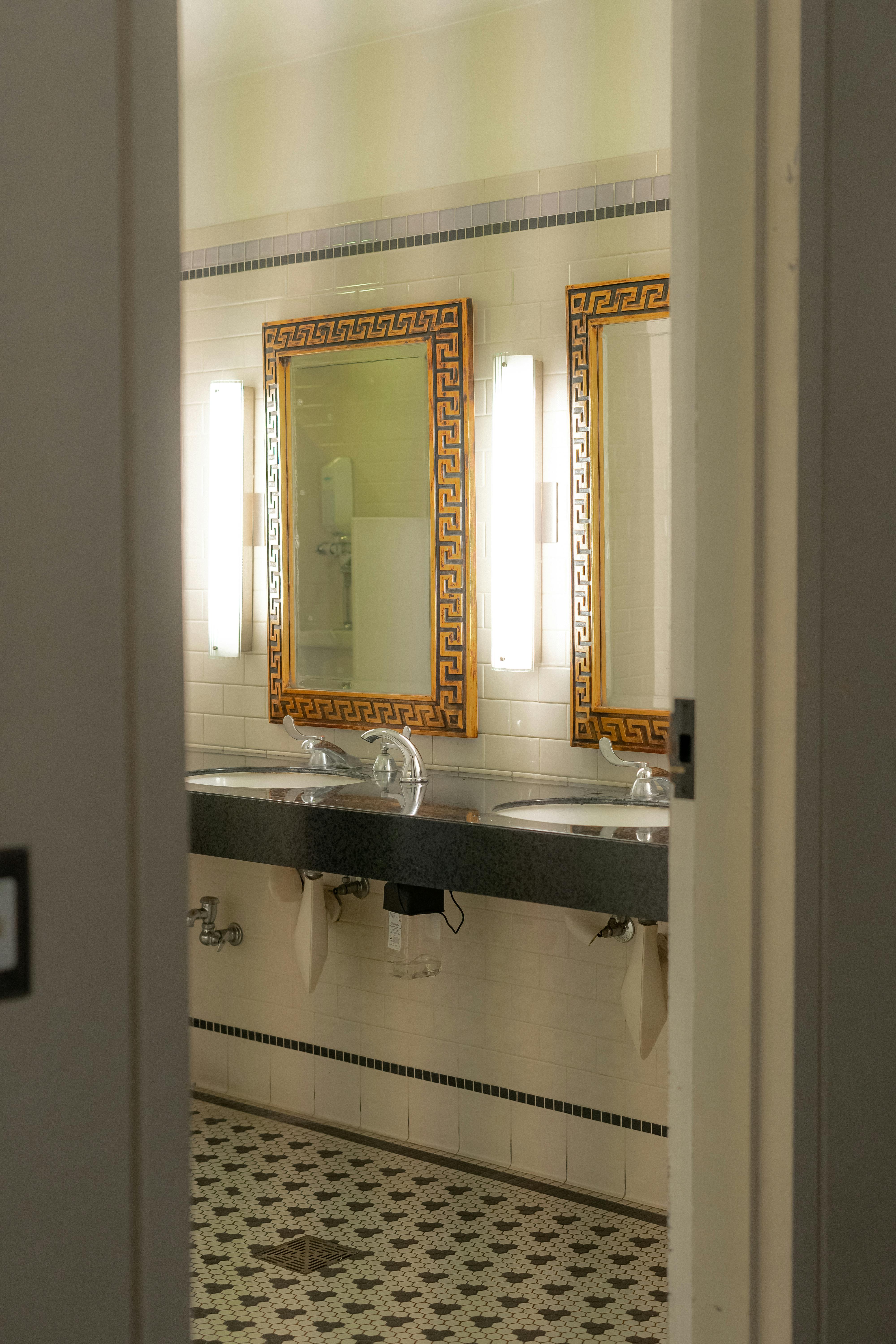 a bathroom with two sinks and mirrors