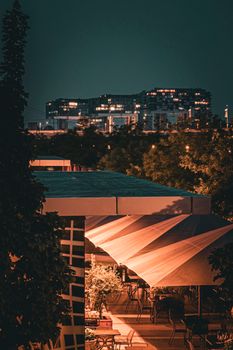 A vibrant evening view of Cologne's urban architecture under city lights.
