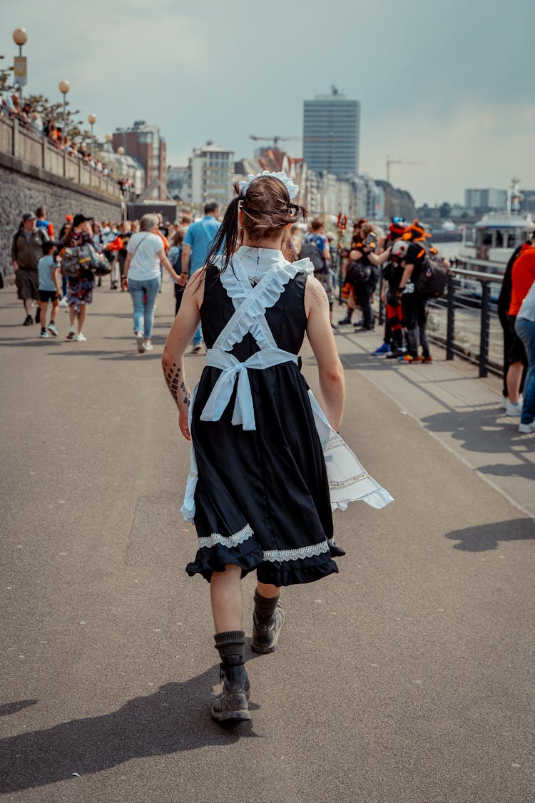 Back View Of Person In Cosplay Costume Walking In City