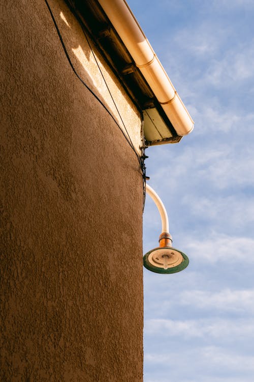 A Lamp Hanging on the Corner of a Building 