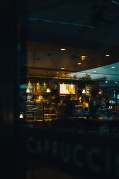 Warm and inviting café interior in Istanbul captured at night, showcasing an urban ambiance.