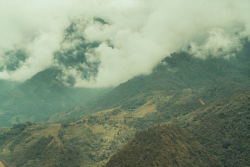 Free Breathtaking view of misty mountains and lush forests shrouded in clouds. Stock Photo