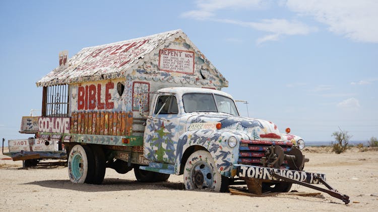 Graffiti On Abandoned Truck On Desert