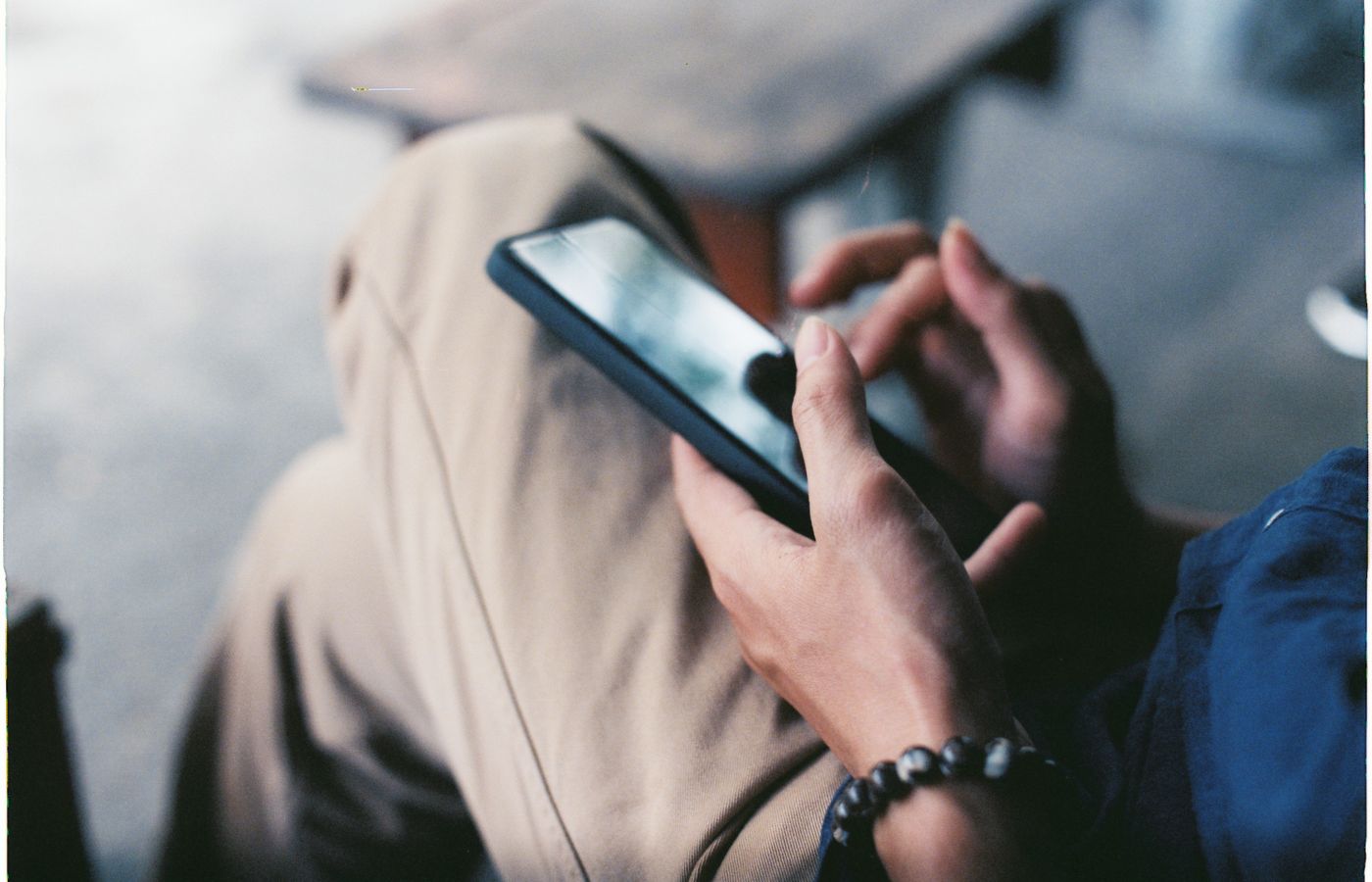 A close-up view of a person using a smartphone indoors, showcasing modern technology.