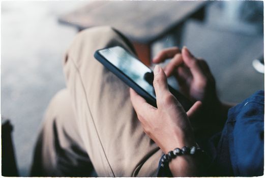 A close-up view of a person using a smartphone indoors, showcasing modern technology.