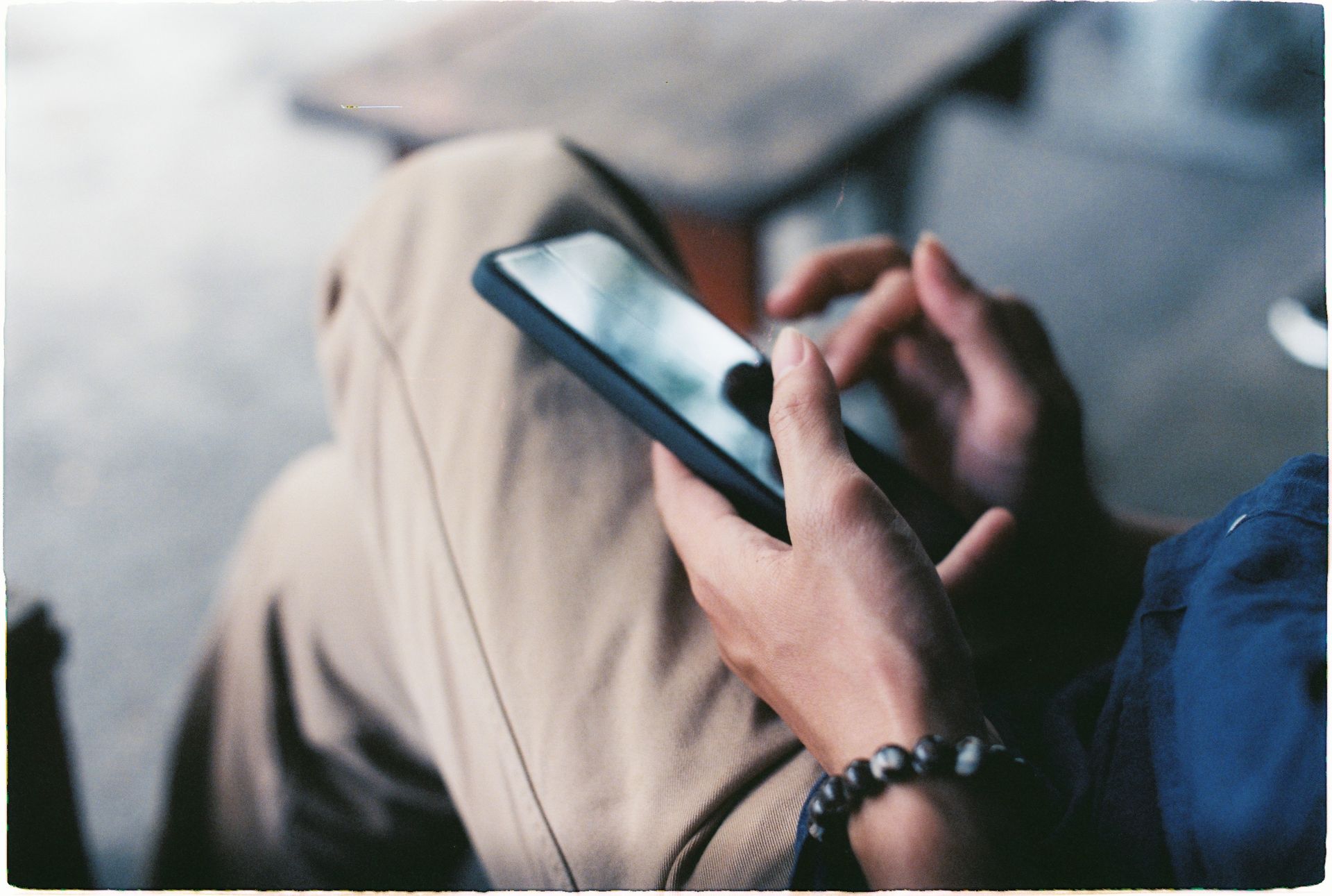 A close-up view of a person using a smartphone indoors, showcasing modern technology.
