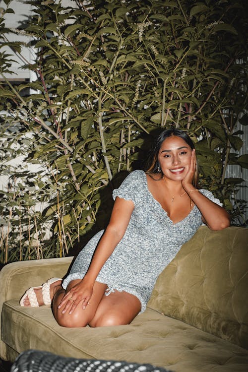 Young Woman Sitting on a Sofa Outside