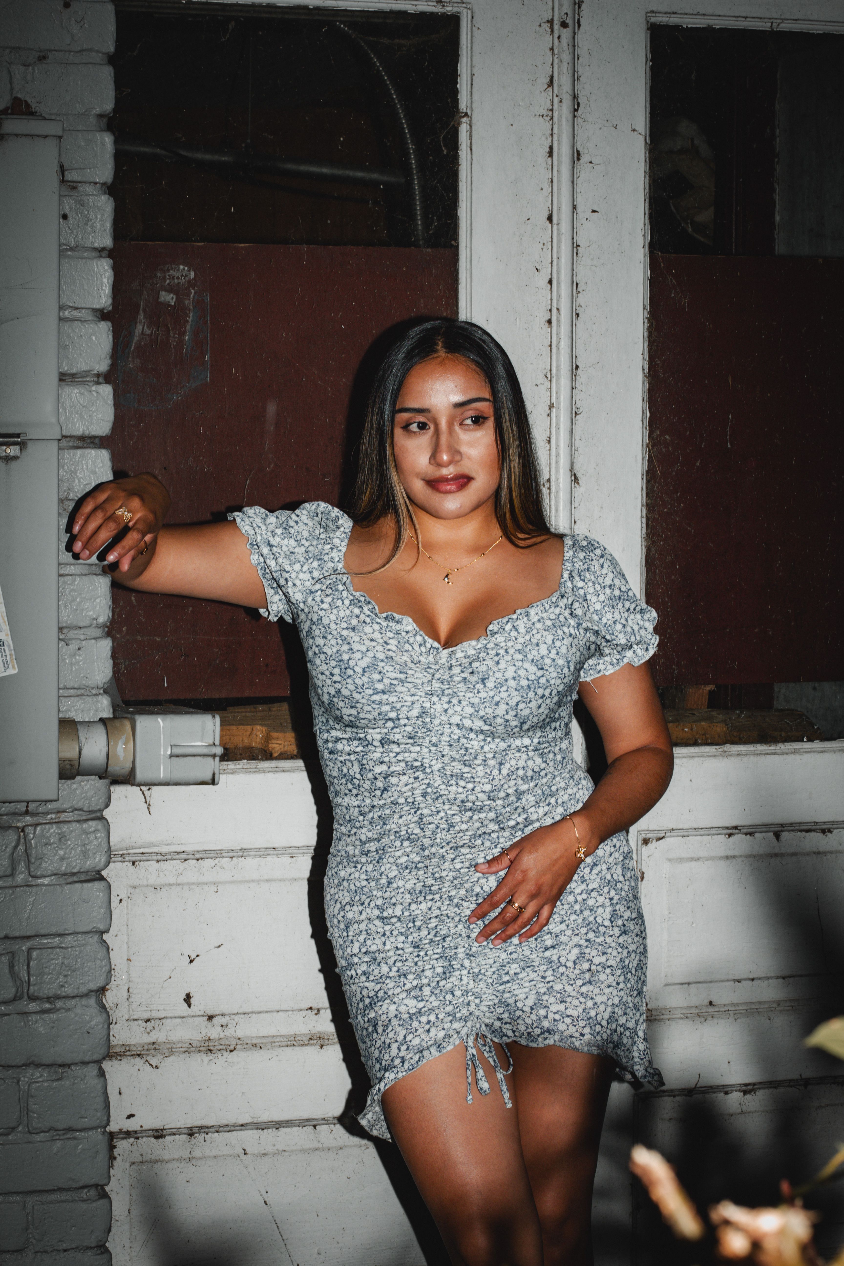 Woman in a Floral Dress Posing in front of a Building · Free Stock Photo