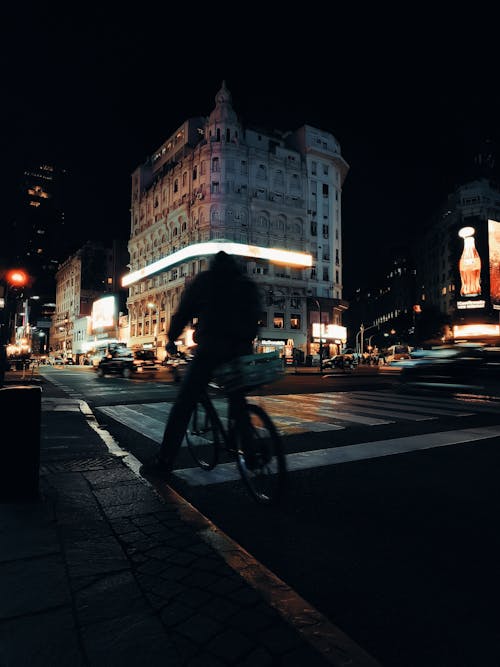 Cyclist in a City at Night