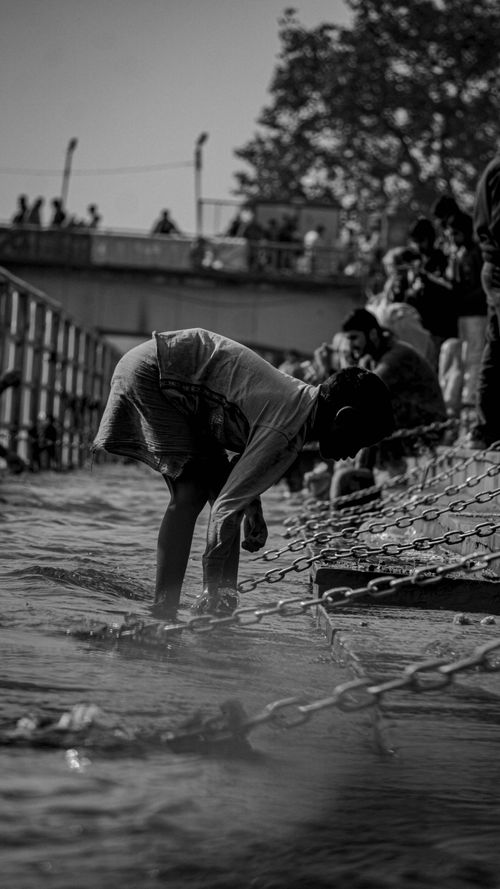 Free A devotee standing by the Ganges River in Haridwar, India, engaging in ritualistic activities. Stock Photo