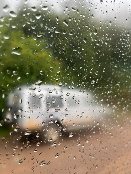 Car on Dirt Road behind Raindrops on Glass