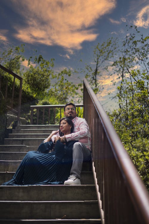 Low Angle Shot of a Couple Sitting on the Steps 