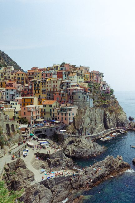 Vibrant Italian village of Manarola perched on cliffs by the sea.