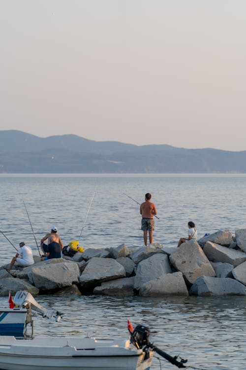 A group of people fishing on the rocks