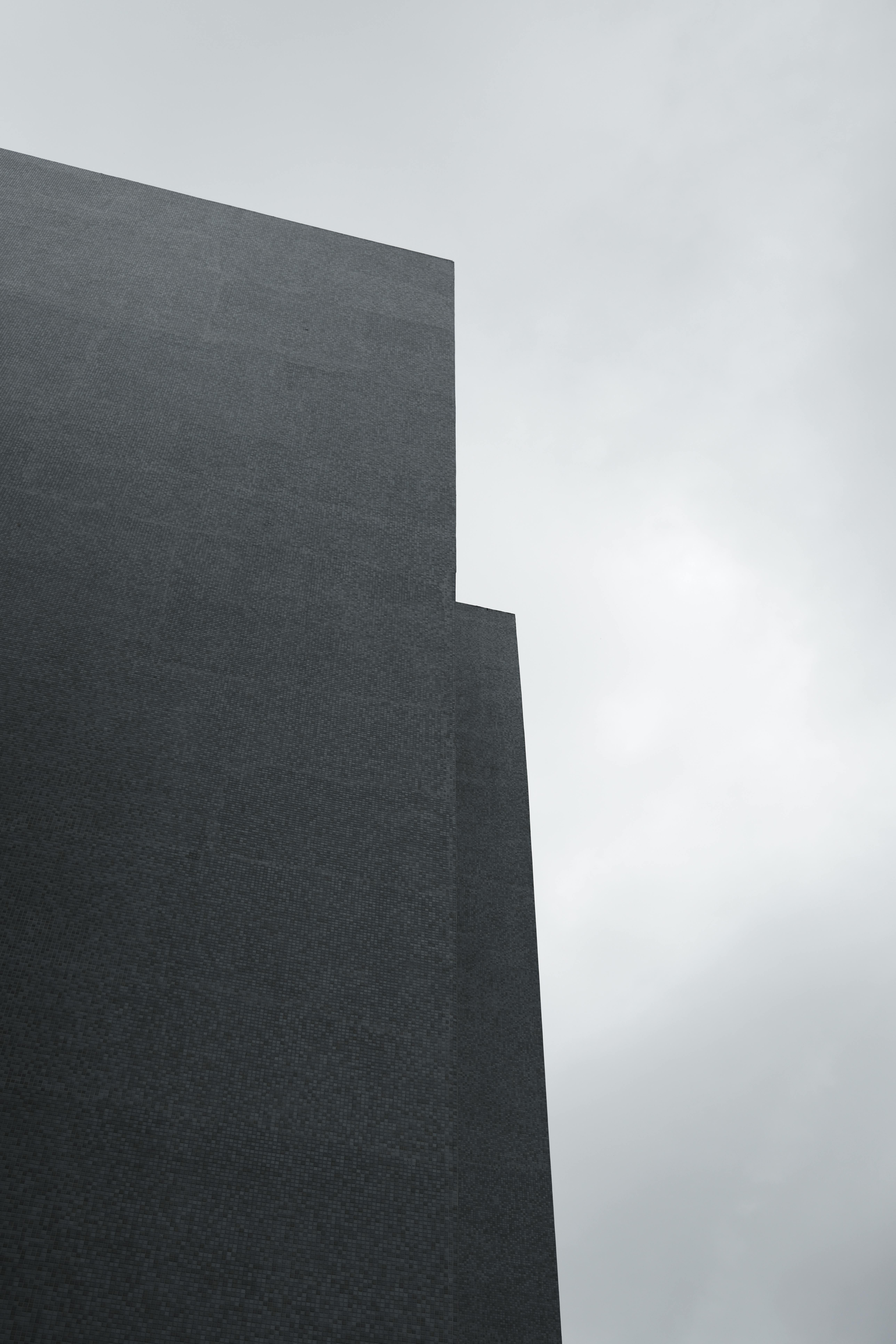 A minimalist view of a skyscraper against a cloudy sky in Istanbul, Turkey.