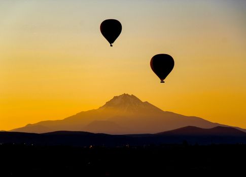 Silhouettes of Hot Air Balloons and Mount Erciyes at Sunset