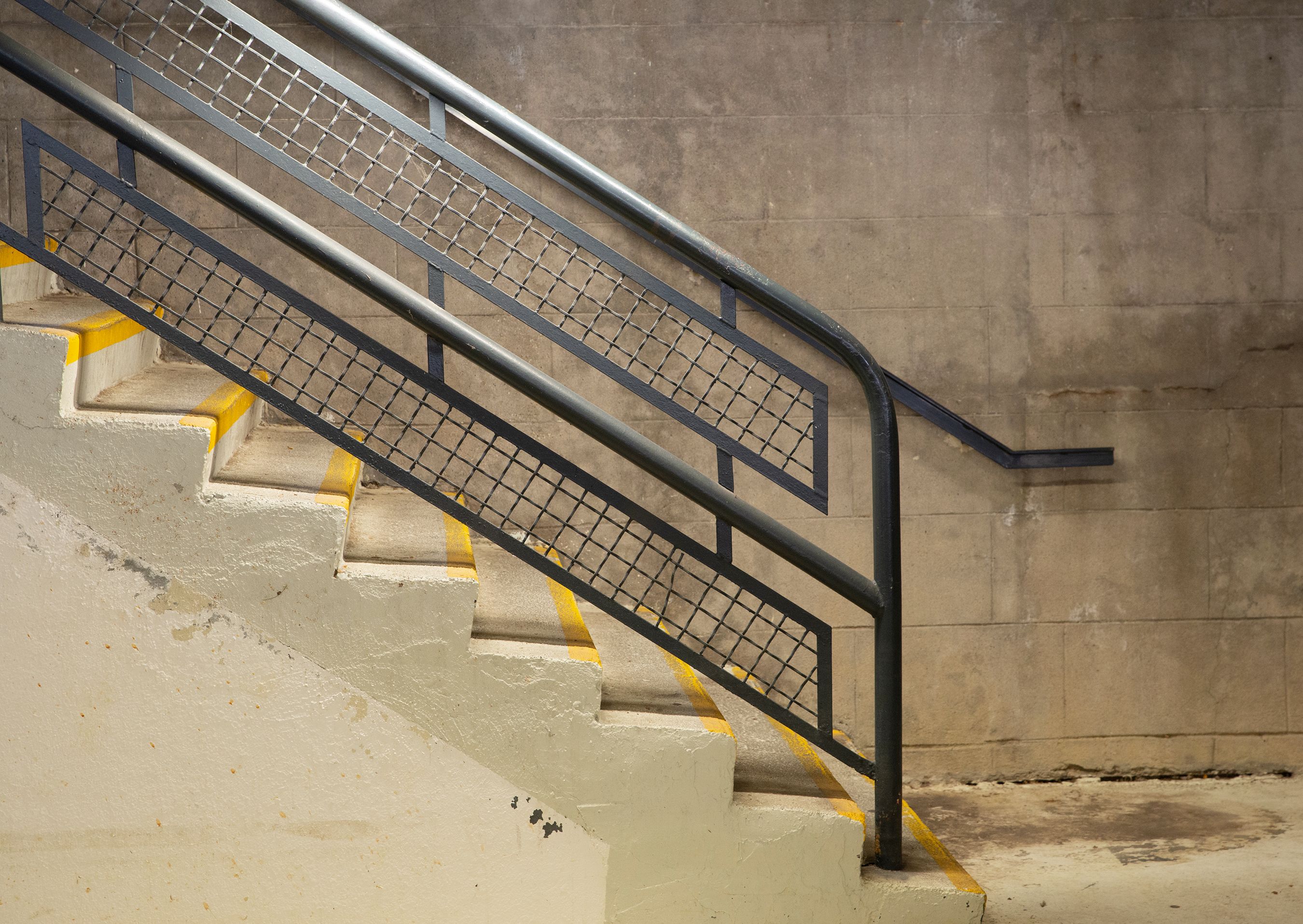 A modern urban staircase in Lyon featuring metal handrails and industrial design.