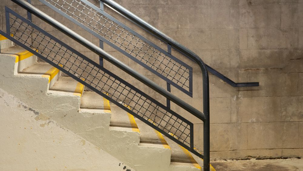 Modern stairwell with metal handrails and concrete walls — mermoz lionel on Pexels