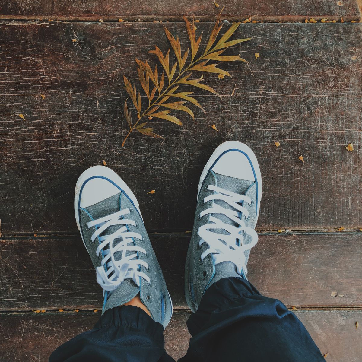 Canvas sneakers on weathered wooden planks — photo by Vicky Tran on Pexels