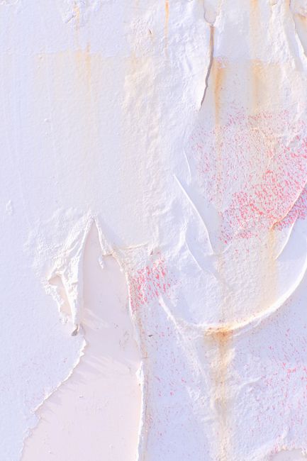 Close-up of an abstract textured wall with white and pale pink hues, artistic and modern look.