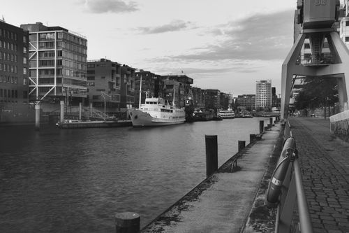 Free Old city waterfront with ships and modern buildings in black and white. Stock Photo