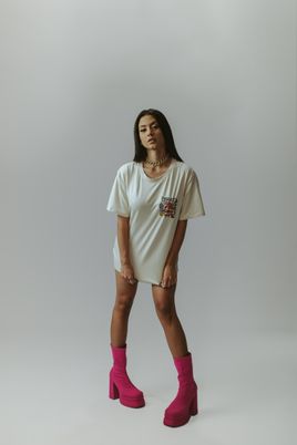 Model wearing an oversized bone-coloured tee dress — photo by Wesley Davi on Pexels