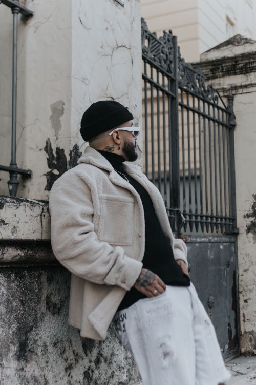 Man in Jacket Leaning on Wall · Free Stock Photo