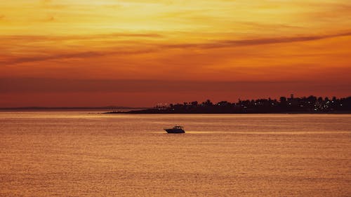 Motorboat on Sea Coast at Sunset