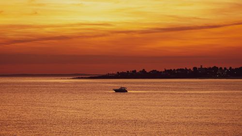 Free Beautiful boat view during sunset over the sea in Piriápolis, Uruguay. Stock Photo