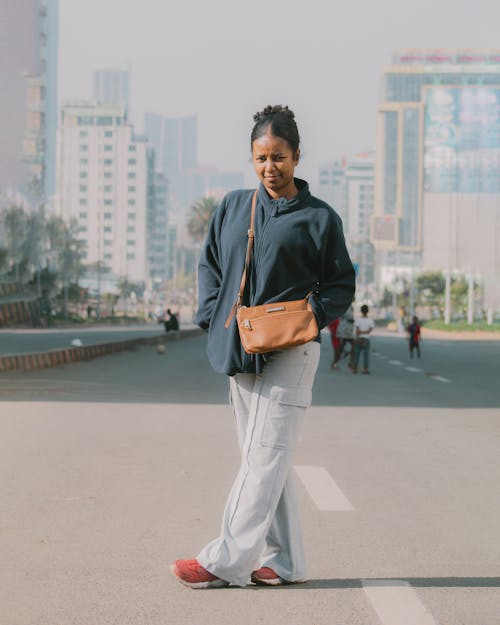 Woman Standing on Street in City