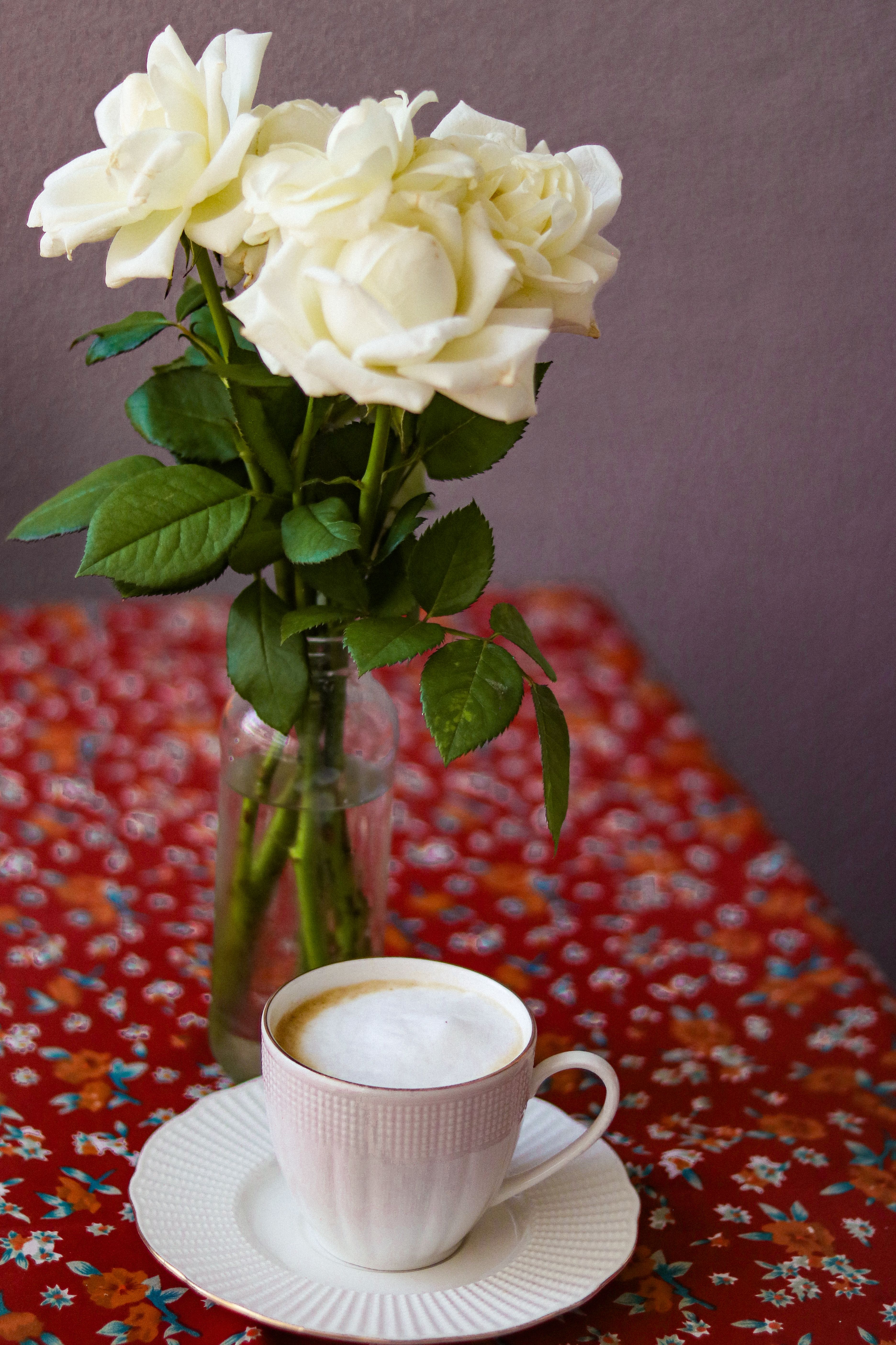 A Cup of Coffee and a Bunch of Flowers on the Table · Free Stock Photo