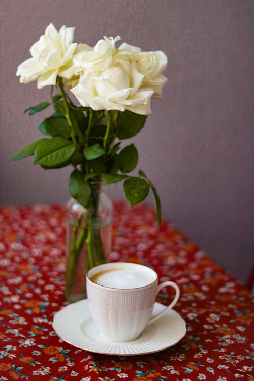 A Coffee and Flowers on a Table