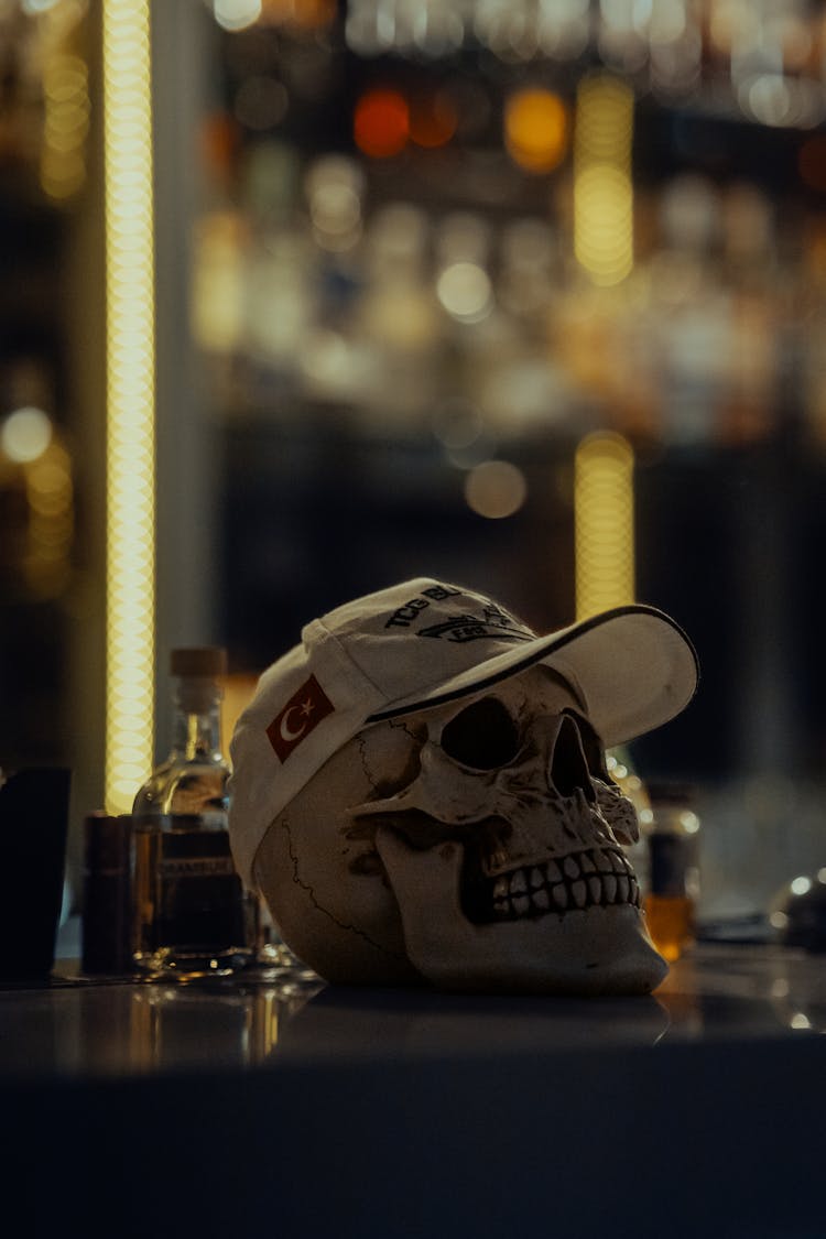 A Decoration Of A Skull With A Cap On The Table 