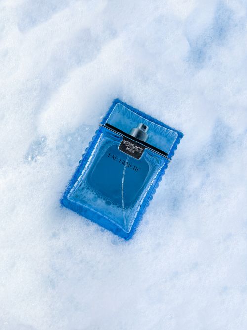 Free Elegant perfume bottle nestled in snow, showcasing luxury and freshness. Stock Photo