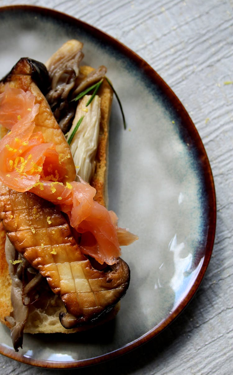 Dish With A Raw Salmon And A Roasted Aubergine On A Ceramic Plate