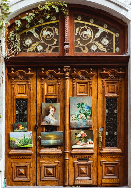 View Art Hanging on Old Wooden Door with Carved Details 
